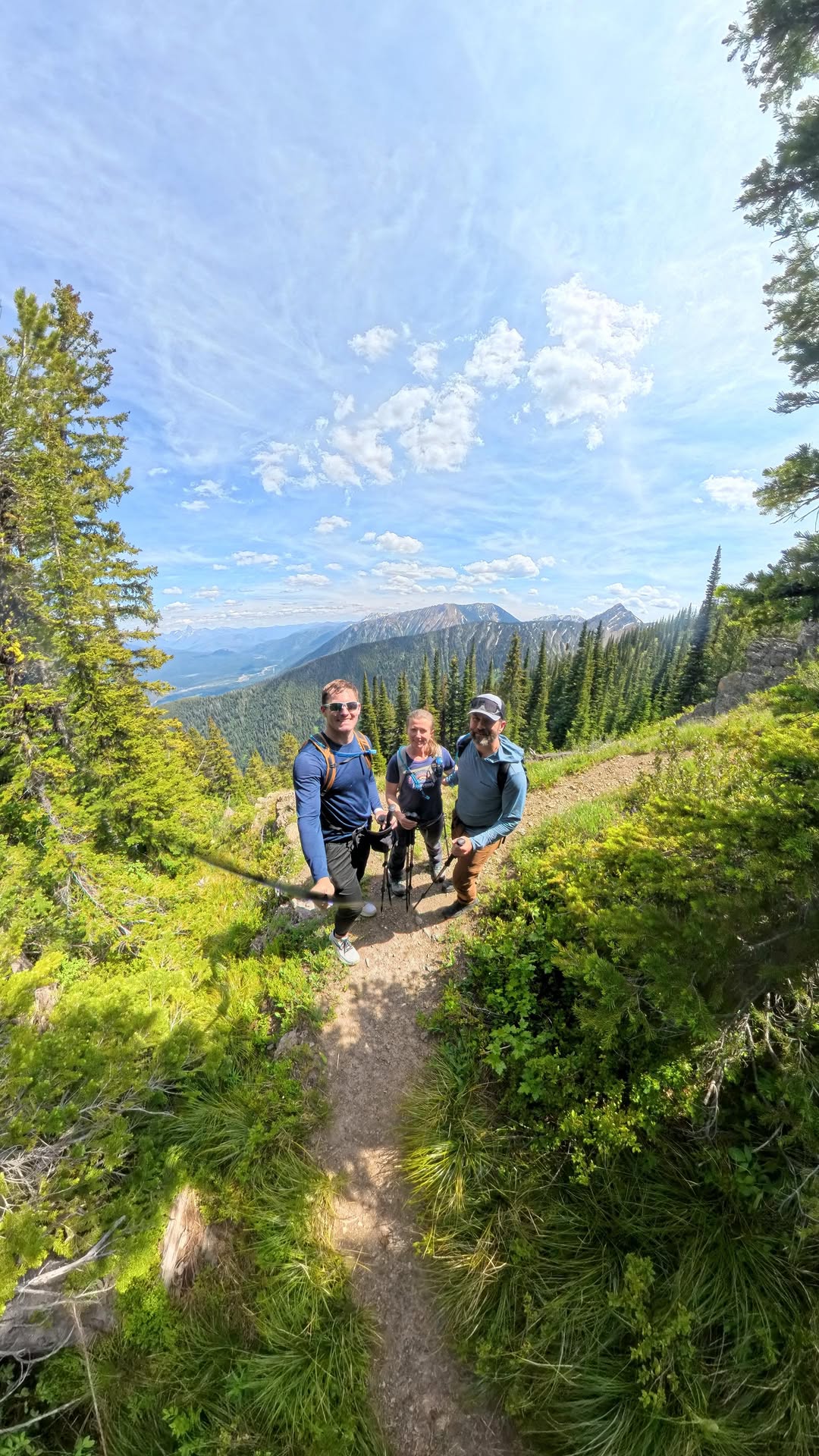 Luke hiking on a mountain trail with friends